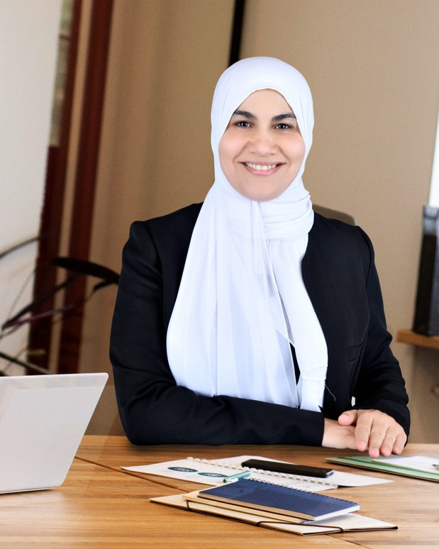 Dr. Diana Abbass reviewing patient notes at her consultation desk in Abu Dhabi