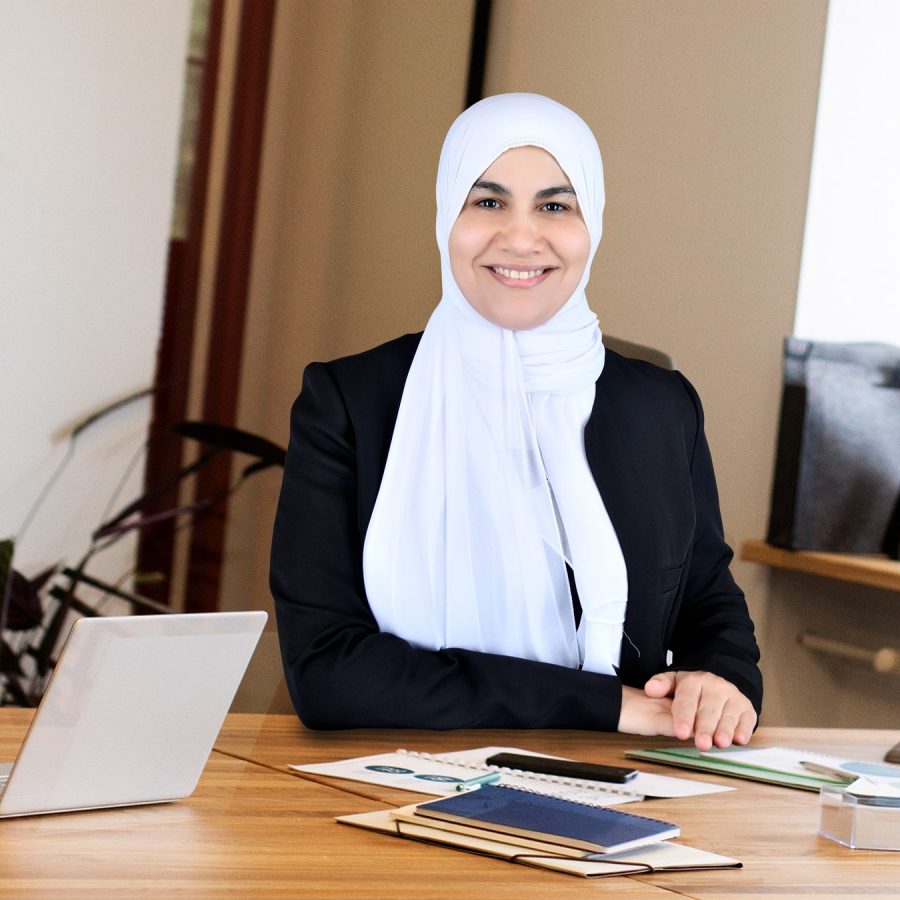 Dr. Diana Abbass reviewing patient notes at her consultation desk in Abu Dhabi
